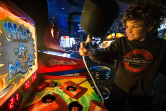 Boy playing whac-a-mole Denver Colorado