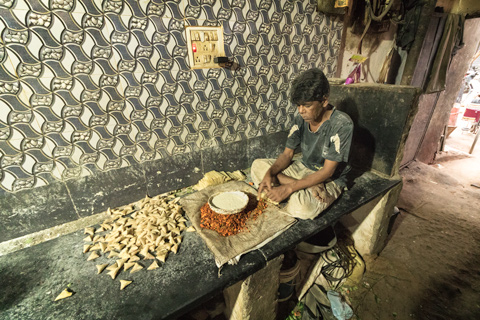 man making samosas in hyderabad india